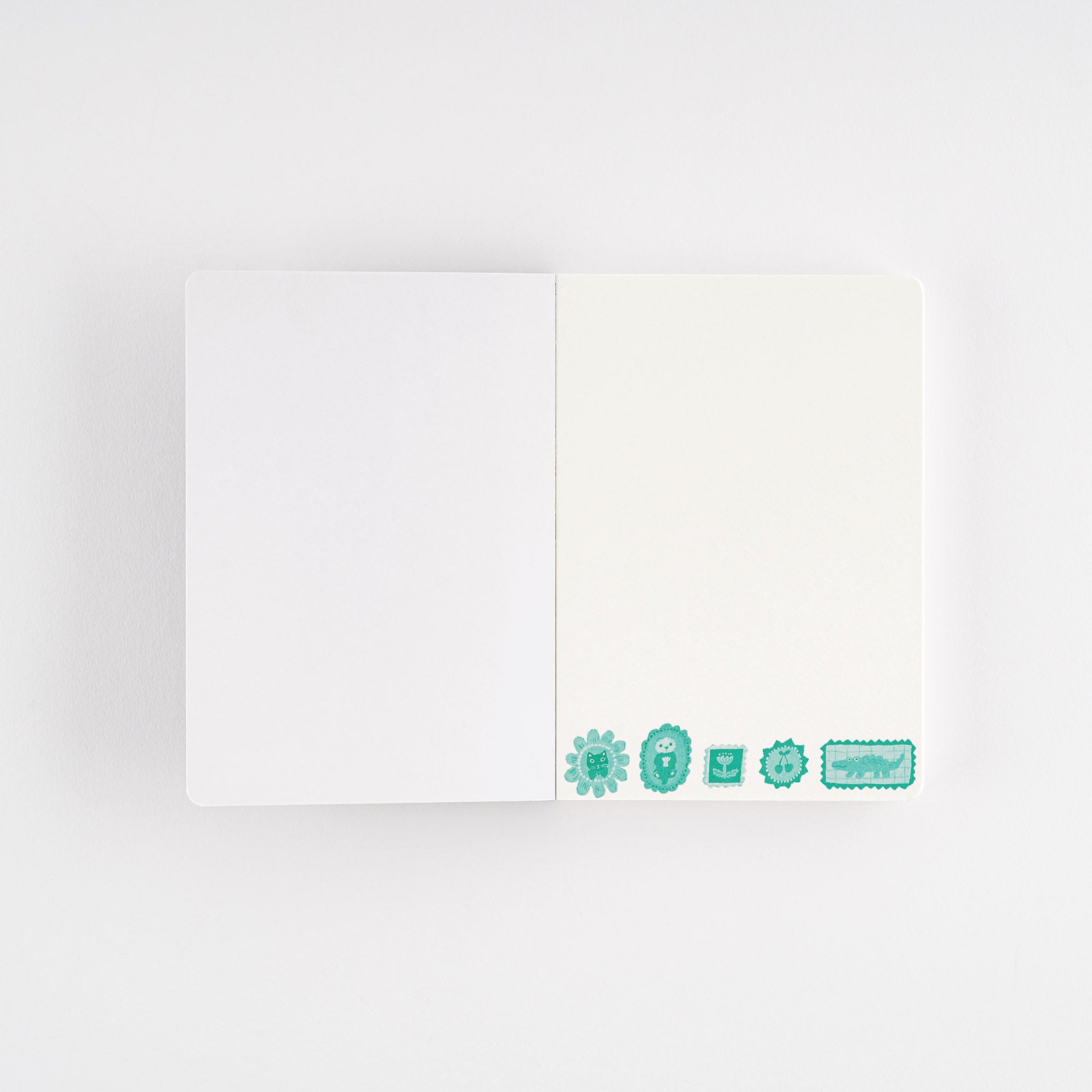 Hobonichi Yumi Kitagishi: Hobonichi Paper(s) Notebook (Take a Look) This A6 notepad has 155 pages. The paper inside is blank except for a lightly printed illustration, and the pages are glued in instead of sewn, making them very easy to rip out for shopping lists or passing along messages. The cover artwork is by illustrator Yumi Kitagishi titled Take a Look.