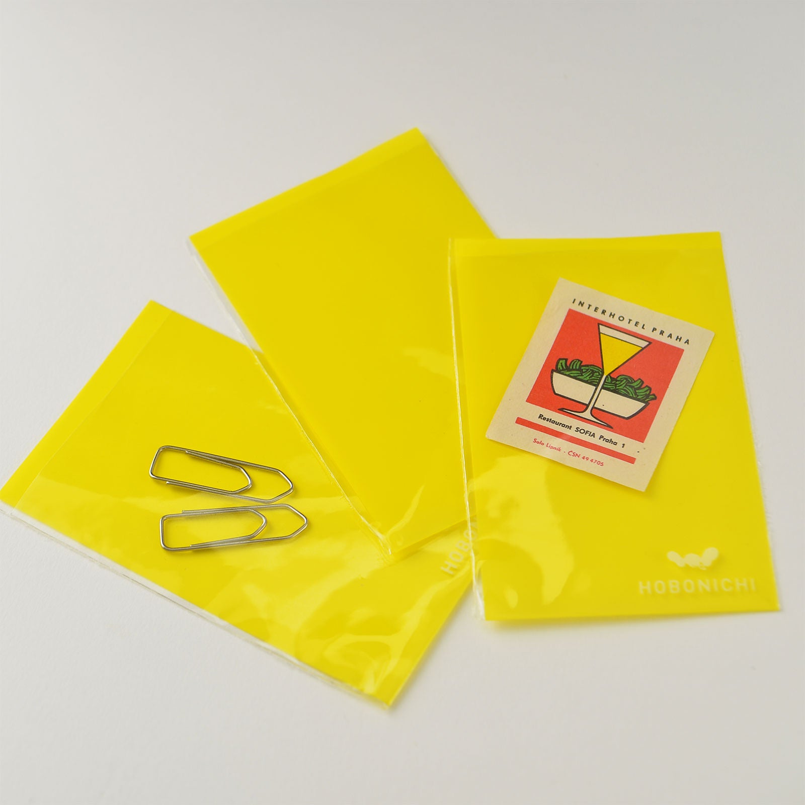 Hobonichi Anything Pocket Clear This adhesive clear envelope can be attached to a page in your techo and provide a storage pocket. Pocket is made of thin plastic, so it does not make your Hobonichi bulky. The Anything Pocket is useful for keeping things in your techo that you would prefer not to tape directly to the page. It can be used to store tickets, papers, stickers etc.