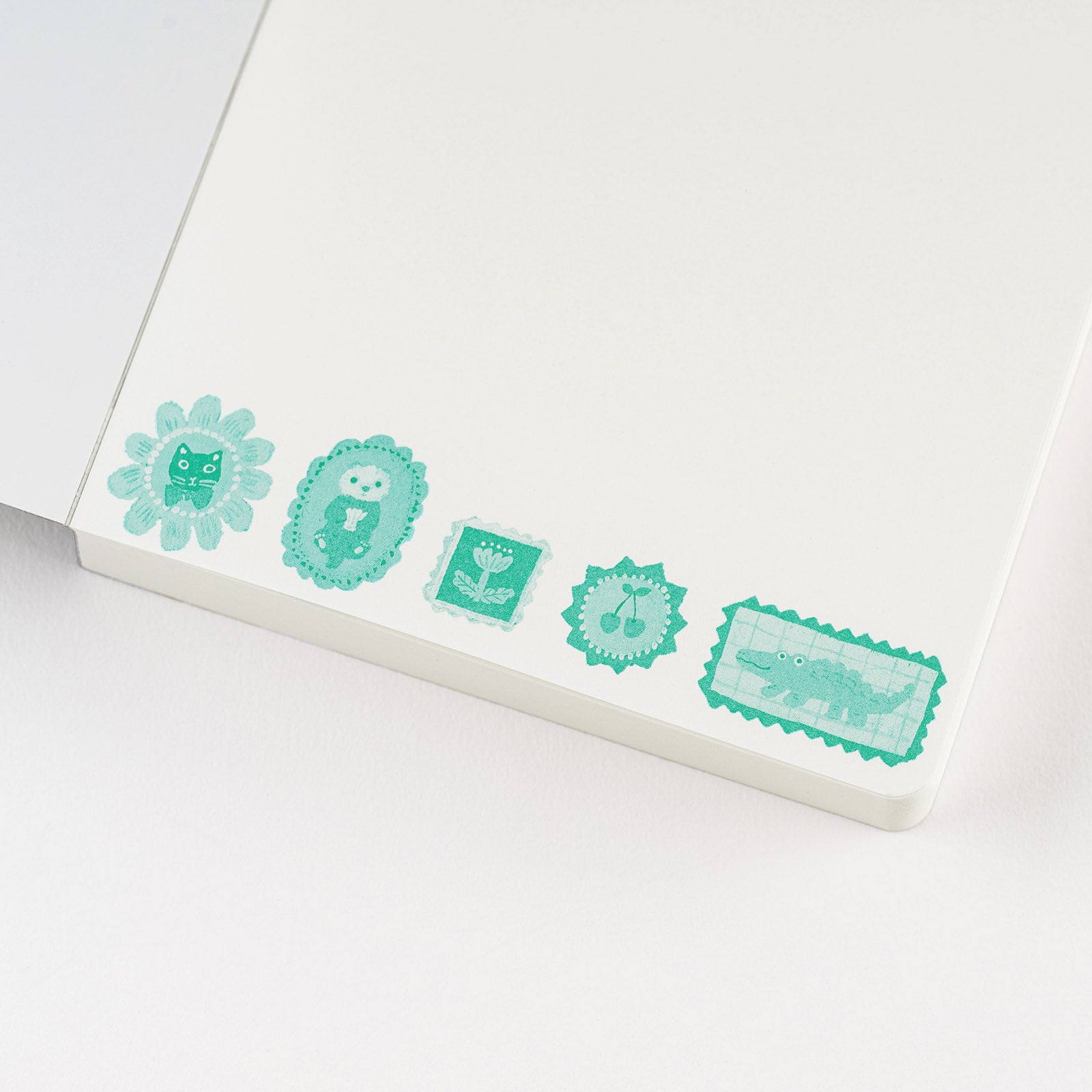 Hobonichi Yumi Kitagishi: Hobonichi Paper(s) Notebook (Take a Look) This A6 notepad has 155 pages. The paper inside is blank except for a lightly printed illustration, and the pages are glued in instead of sewn, making them very easy to rip out for shopping lists or passing along messages. The cover artwork is by illustrator Yumi Kitagishi titled Take a Look.