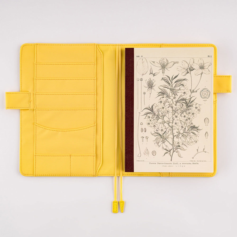 Hobonichi Plain Notebook A5 Tomitaro Makino : Yamazakura Notebook features an illustration of a Yamazakura cherry tree created by the botanist Tomitaro Makino in 1900. Makino is known for his detailed works of art. This notebook has Tomoe River paper, opens completely flat, and contains graph paper divided into 4 colors.